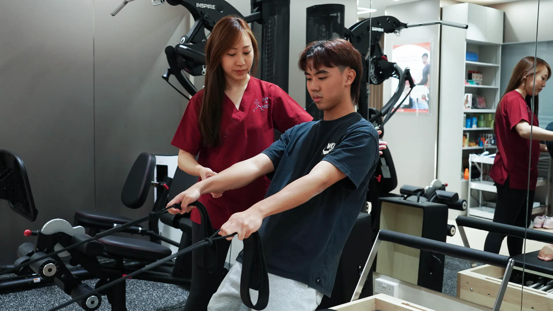 Physio and Sole Clinic practitioner supporting a patient during treatment