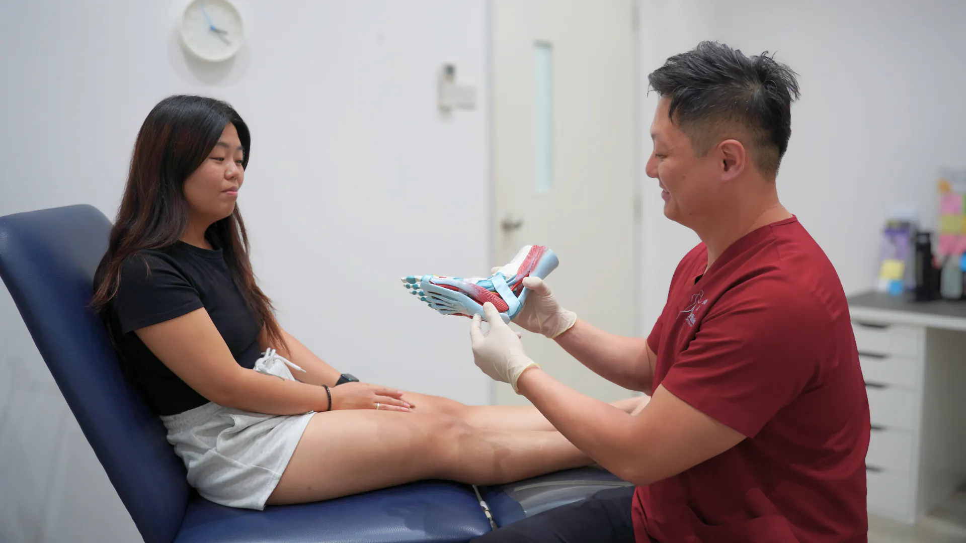 Podiatrist explaining foot anatomy to a patient
